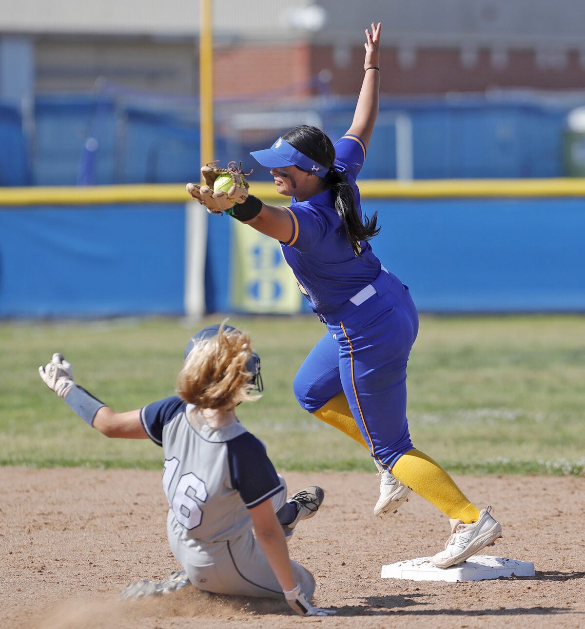 Fountain Valley's Kira Velasco snags the throw to second to force out a steal attempt by Newport Harbor's Sienna Schneider.