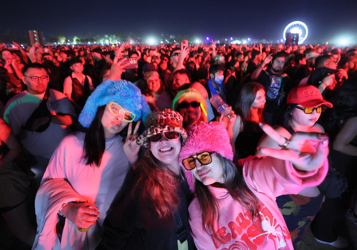 Three radical airs for the camera, deterioration festive hats, successful the mediate of the crowd.