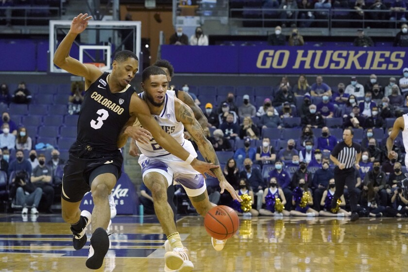 Colorado guard Keeshawn Barthelemy (3), tries to stop a drive by Washington guard Terrell Brown Jr., right, during the first half of an NCAA college basketball game, Thursday, Jan. 27, 2022, in Seattle. (AP Photo/Ted S. Warren)