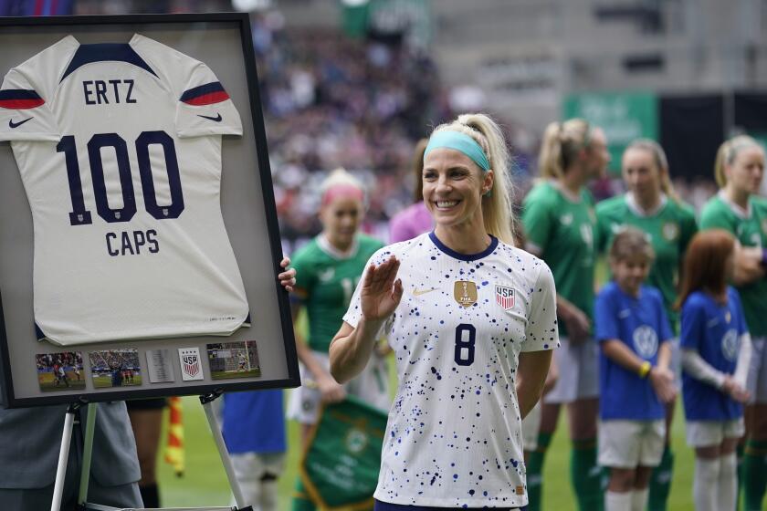 United States midfielder Julie Ertz (8) wavs after she was presented a jersey marking her 100th match before an international friendly soccer match against the Ireland in Austin, Texas, Saturday, April 8, 2023. (AP Photo/Eric Gay)