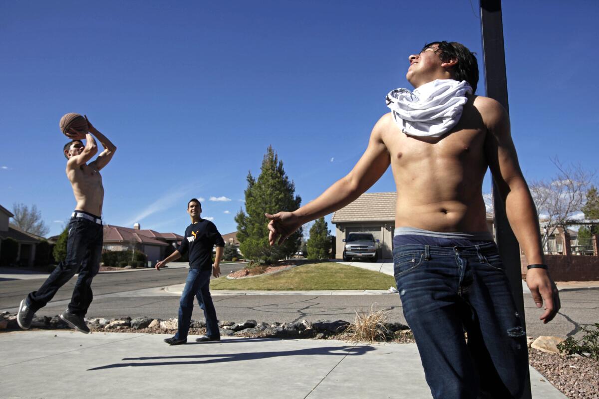 Zach, left, and Isaiah Bowers, right, play a casual game of basketball. On their fundamentalist compound, they always wore long-sleeved shirts -- and long underwear.