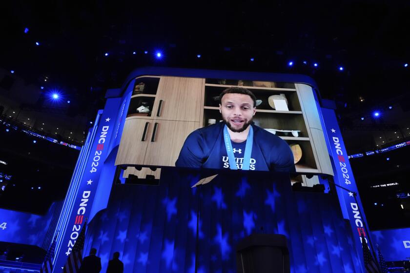 Golden State Warriors guard Stephen Curry speaks as he is seen on the screen during the Democratic National Convention Thursday, Aug. 22, 2024, in Chicago. (AP Photo/Brynn Anderson)