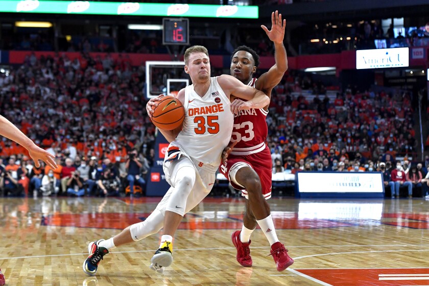 Syracuse guard Buddy Boeheim, left, drives as Indiana guard Tamar Bates defends during the first half of an NCAA college basketball game in Syracuse, N.Y., Tuesday, Nov. 30, 2021. (AP Photo/Adrian Kraus)