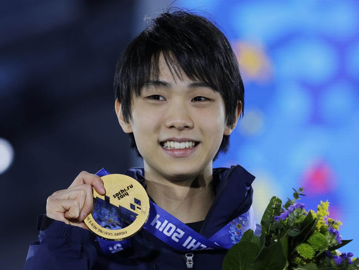 Japanese figure skater Yuzuru Hanyu poses with his gold medal during the 2014 Winter Olympics in Sochi, Russia.
