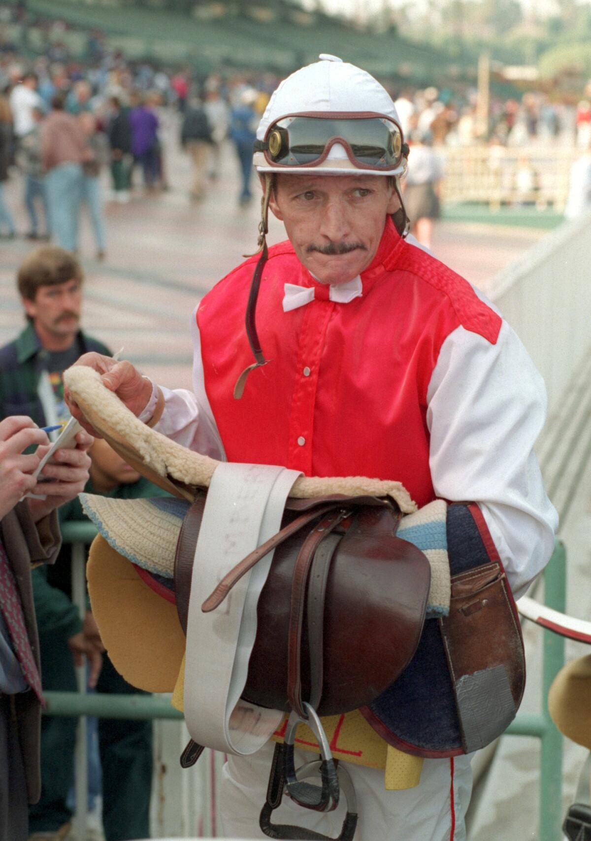 Jerry Lambert watches the scales after completing a race at Santa Anita in 1996.