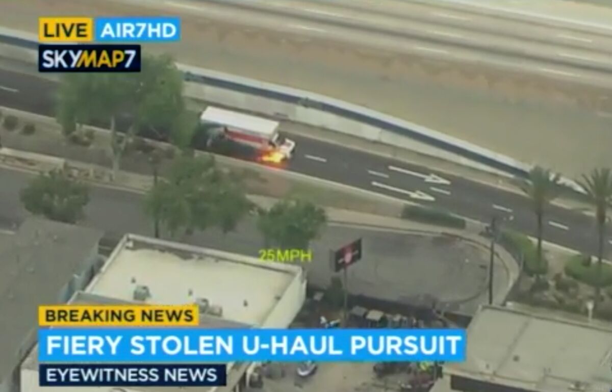 In this aerial image take from video provided by KABC-TV, shows fire coming from a U-Haul truck as police follow in pursuit on a freeway exit in Bellflower, Calif., an area of Los Angeles on Tuesday, May 11, 2021. A reportedly stolen U-Haul truck towing a trailer was pursued on Southern California freeways early Tuesday until it burst into flame and the driver unsuccessfully tried to run away. (KABC-TV via AP)