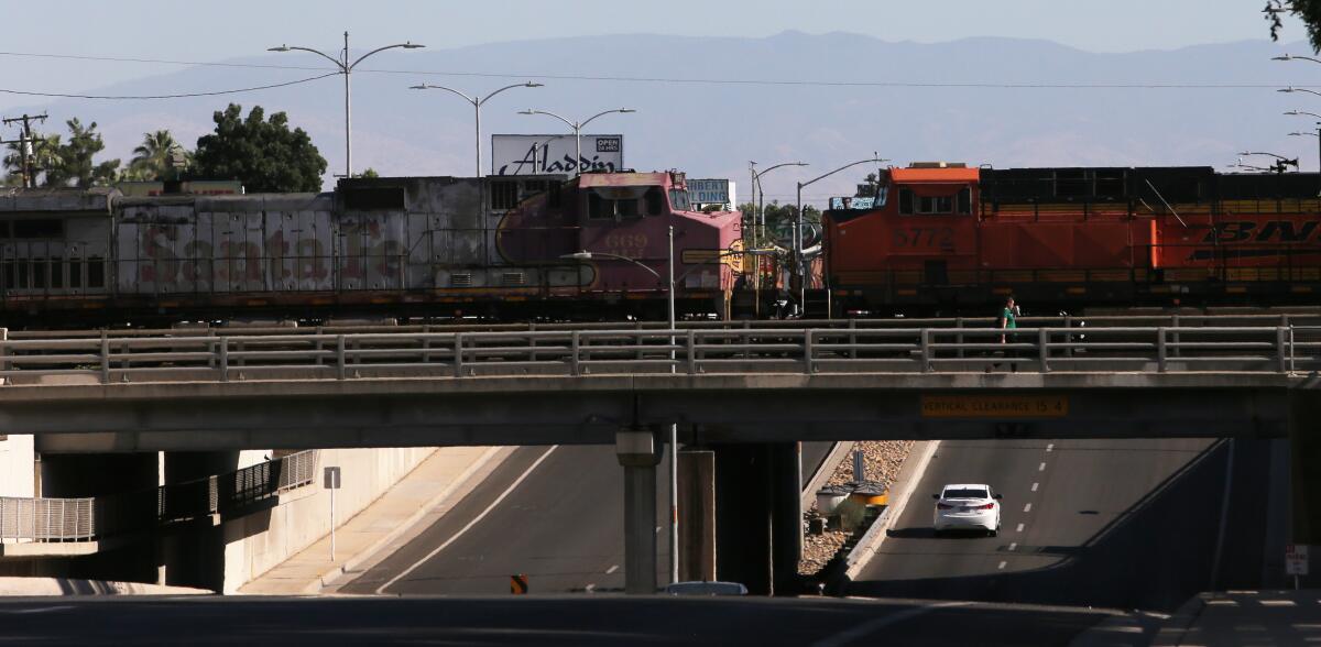 A freight train crosses over a roadway.