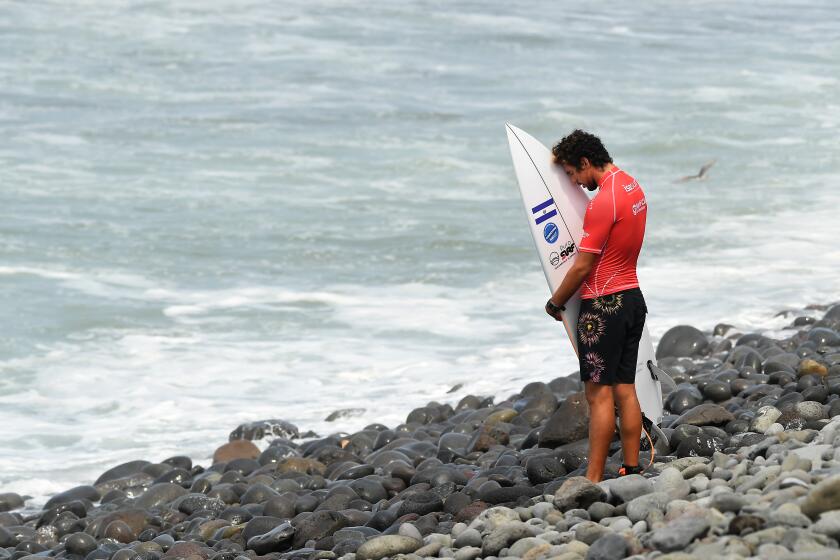 -SP-June 4, 2021: Surfer Bryan Perez prays before competing in the Surf City El Salvador ISA World Surfing Games. (Wally Skalij / Los Angeles Times)