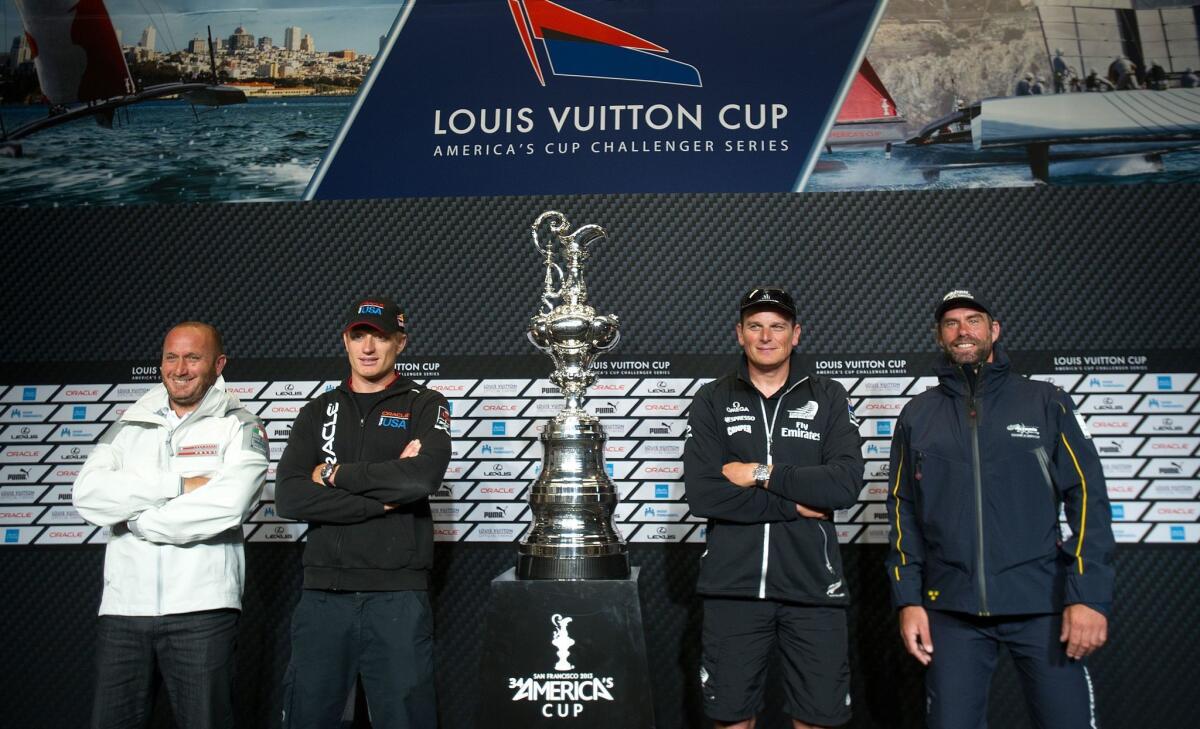 Skippers pose with the America's Cup trophy following a news conference Friday in San Francisco. From left are Luna Rossa Challenge's Max Sirena, Team Oracle USA's Jimmy Spithill, Emirates Team New Zealand's Dean Barker and Artemis Racing's Iain Percy.