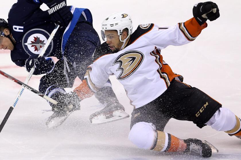 The Ducks' Emerson Etem, right, and Winnipeg's Blake Wheeler battle for the puck on April 20, 2015.