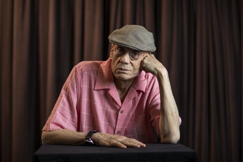 Author James Ellroy, in pink shirt and dapper hat, at the L.A. Times Festival of Books photo studio. 