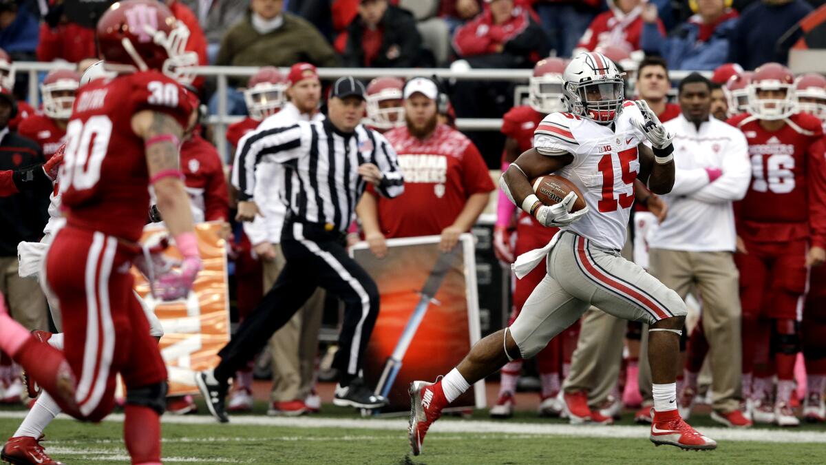 Ohio State running Ezekiel Elliott (15) breaks into the clear on a 55-yard touchdown run against Indian in the second half Saturday.