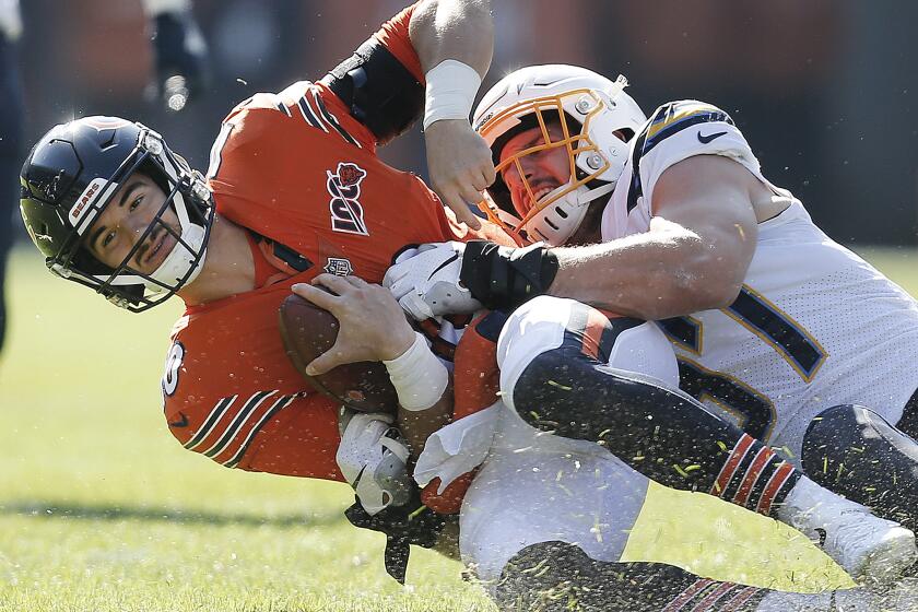 CHICAGO, ILLINOIS - OCTOBER 27: Joey Bosa #97 of the Los Angeles Chargers takes down Mitchell Trubisky #10 of the Chicago Bears during the first half at Soldier Field on October 27, 2019 in Chicago, Illinois. (Photo by Nuccio DiNuzzo/Getty Images)