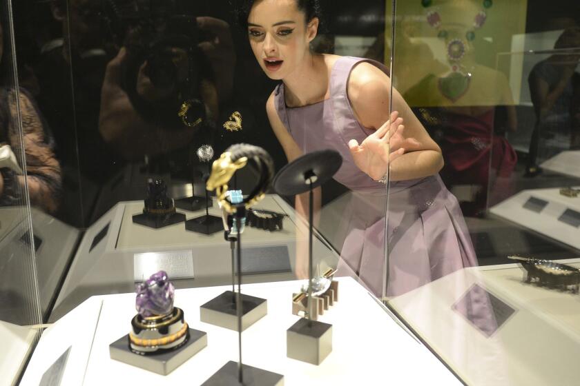Krysten Ritter views some of the pieces on display at "A Quest for Beauty: The Art Of Van Cleef & Arpels" at the Bowers Museum in Santa Ana