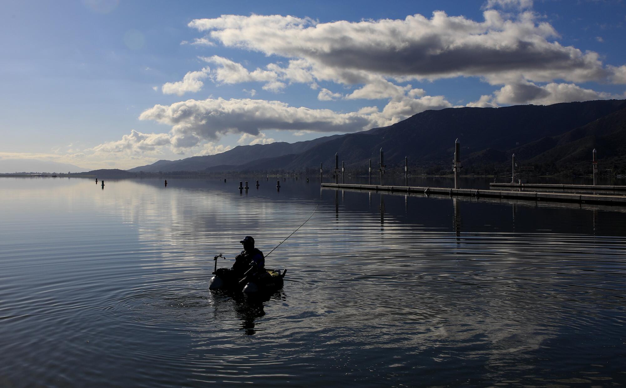 Fisherman Johnathan O. Skinner floats out to his favorite spot on Lake Elsinore, trying to catch a catfish or a bass.