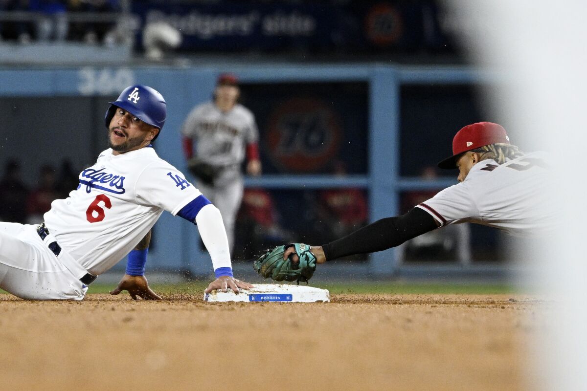 Dodgers baserunner David Peralta touches second base after being tagged out by Diamondbacks second baseman Ketel Marte.
