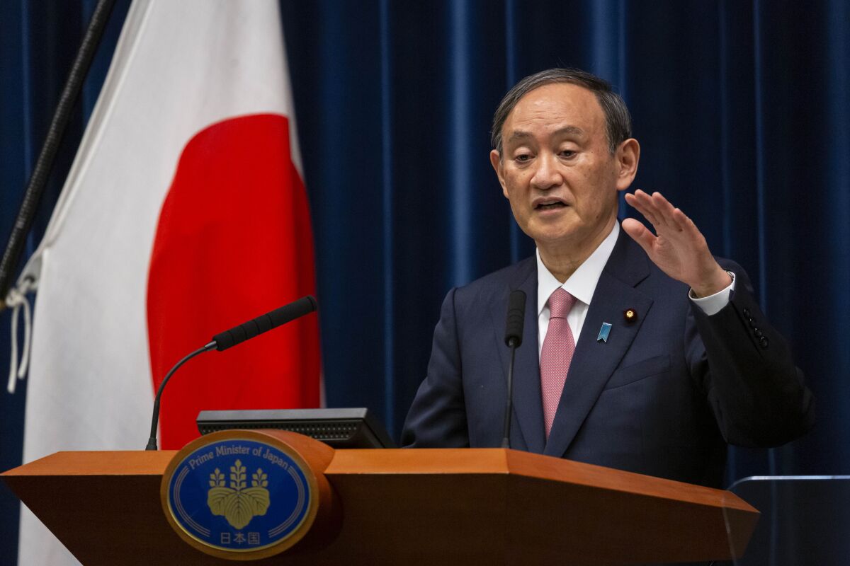 Japanese Prime Minister Yoshihide Suga speaks during a press conference at the prime minister's official residence on Friday, May 14, 2021, in Tokyo. Suga announced that the current coronavirus state of emergency covering Tokyo, Osaka and a number of other areas, will be extended to the prefectures of Hokkaido, Okayama and Hiroshima from Sunday as Japan battles a fourth wave of coronavirus. (Yuichi Yamazaki/Pool Photo via AP)