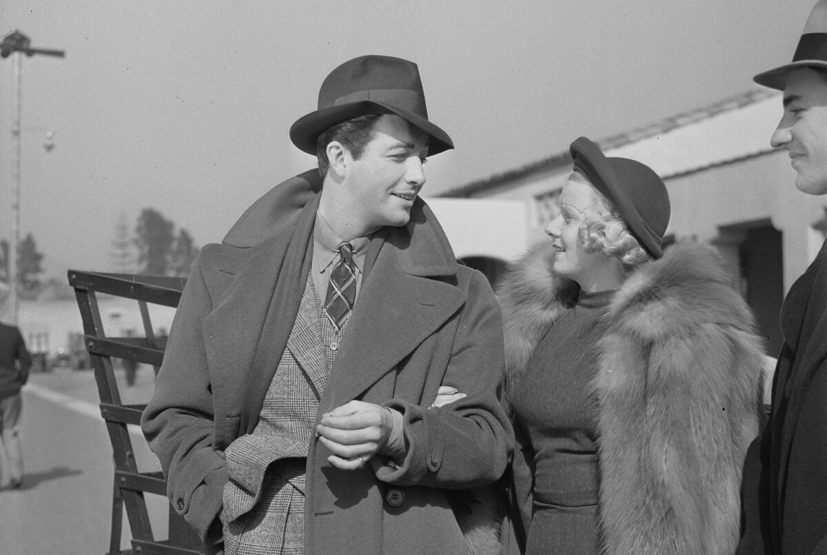 Actress Jean Harlow on the arm of actor Robert Taylor, circa 1937.