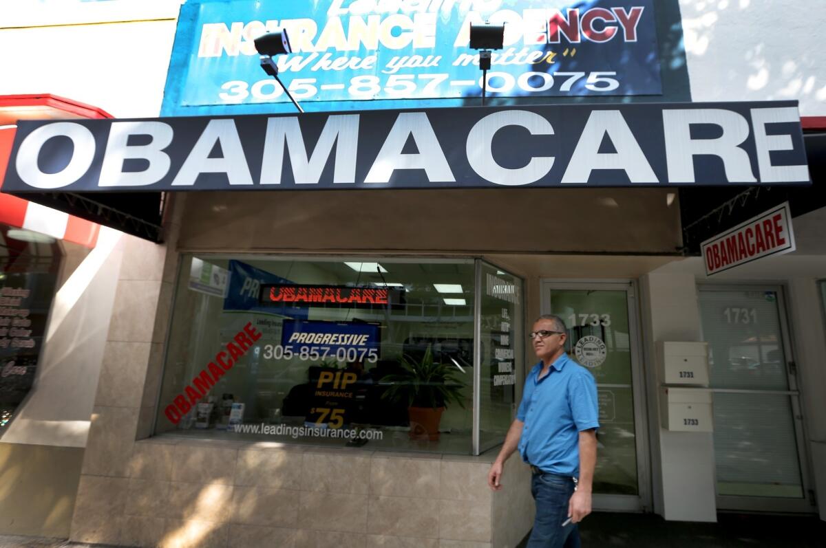 Hisham Uadadeh walks out of Leading Insurance Agency in Miami last month after enrolling in a health insurance plan under the Affordable Care Act. The Obama administration announced Wednesday that it would allow insurers to continue renewing policies that don't meet the new law's standards through Oct. 1, 2016.