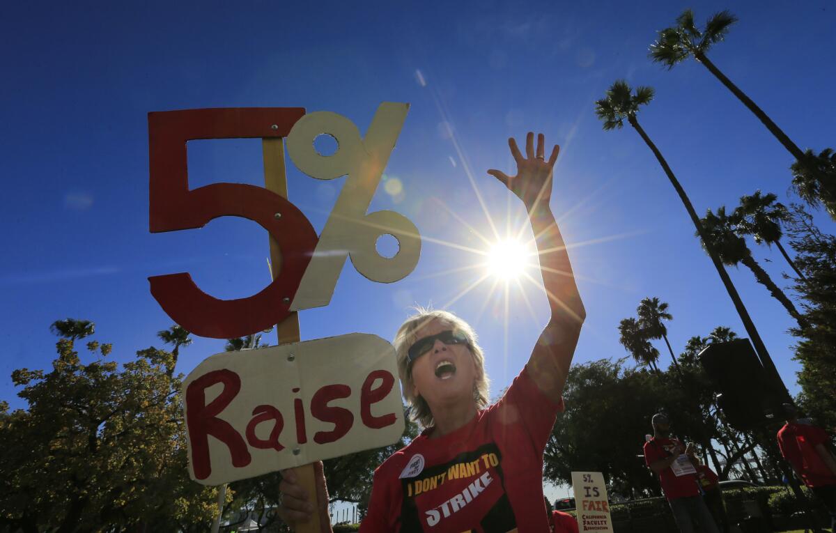 Cal State Fullerton English teacher Michelle Luster joins hundreds of faculty members rallying for pay raises outside a Board of Trustees meeting in Long Beach in November.