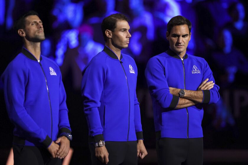 Team Europe's Novak Djokovic, Rafael Nadal and Roger Federer line up on the court ahead of day one of the Laver Cup at the O2 Arena in London, Friday Sept. 23, 2022. (John Walton/PA via AP)