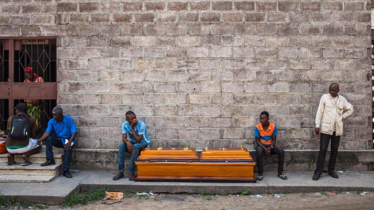 Opposition supporters wait Oct. 31 for bodies to be released from the Bondeko morgue in Congo's capital, Kinshasa, after clashes with the security forces.