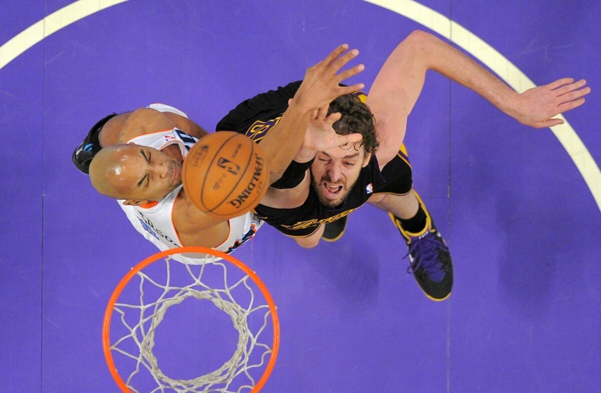 The Lakers' Pau Gasol tries to score inside against the Charlotte Bobcats' Gerald Henderson during a game at Staples Center.