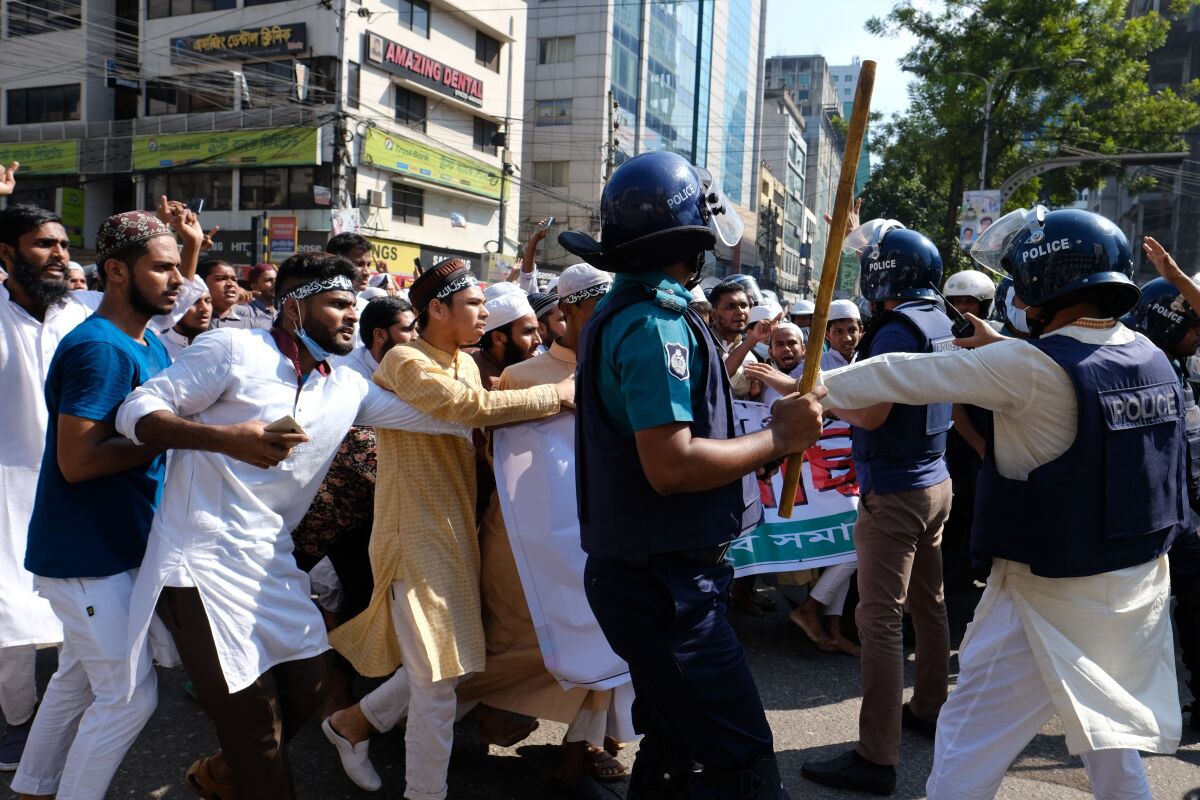 Police clash with Muslim devotees during a protest over an alleged insult to Islam, outside the country’ main Baitul Mukarram Mosque in Dhaka, Bangladesh, Friday, Oct. 15, 2021. Friday’s chaos in Dhaka followed reported incidents of vandalism of Hindu temples in parts of the Muslim-majority Bangladesh after photographs of a copy of the Holy book Quran at the feet of of a Hindu Goddess went viral on social media in a temple at Cumilla district in eastern Bangladesh. (AP Photo/Mahmud Hossain Opu, File)