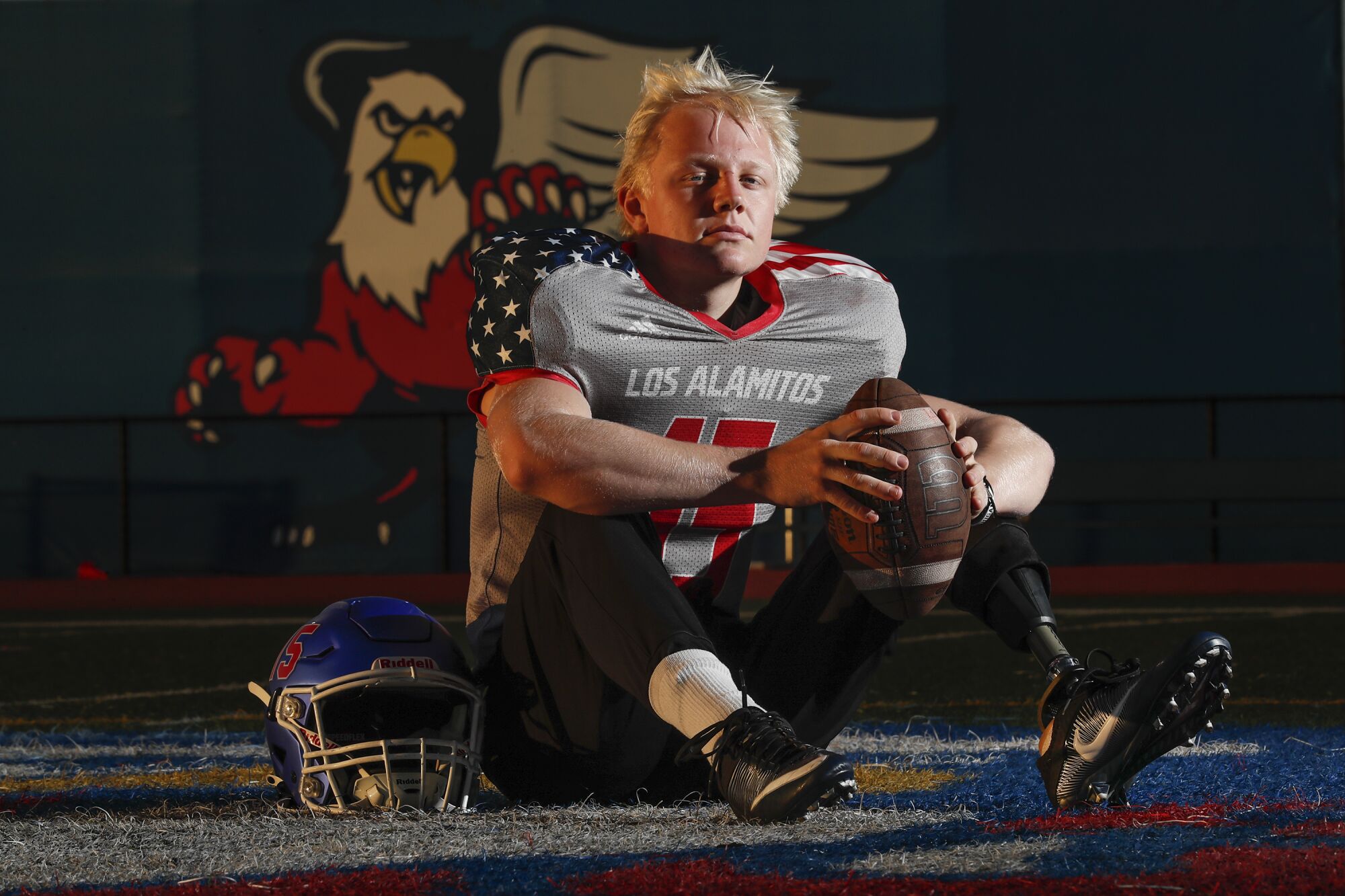 Los Alamito's long snapper Carson Fox looks at the camera while seated on a soccer field.