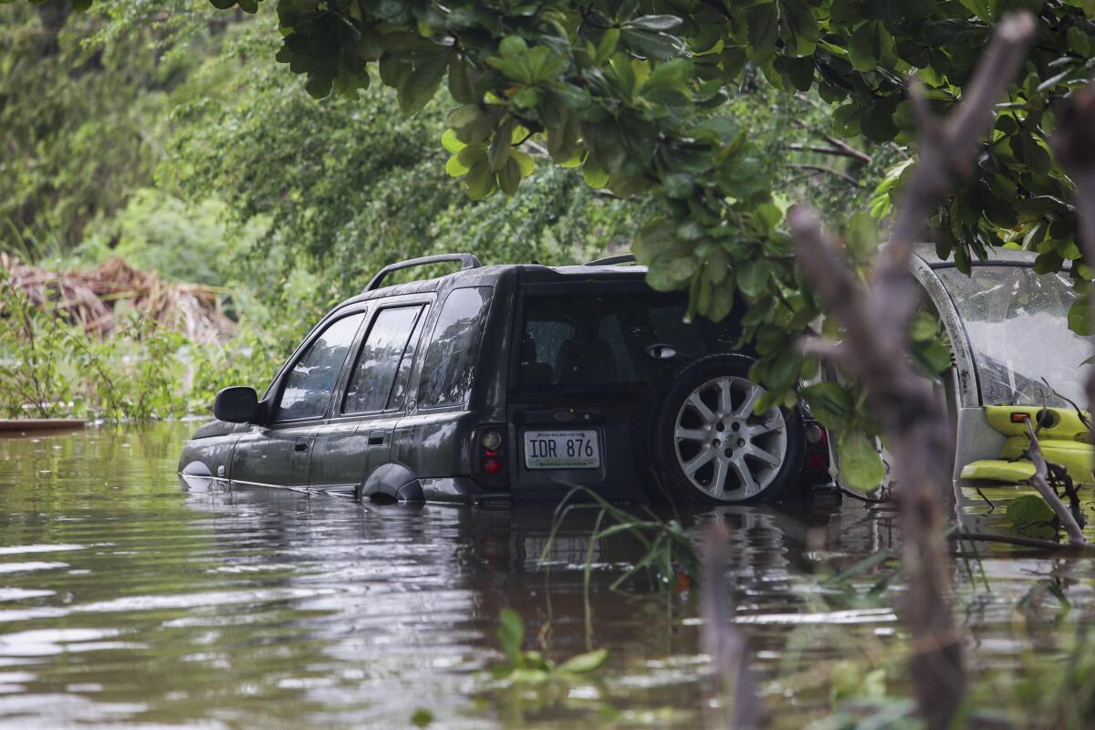 Vehicle half-submerged in floodwater