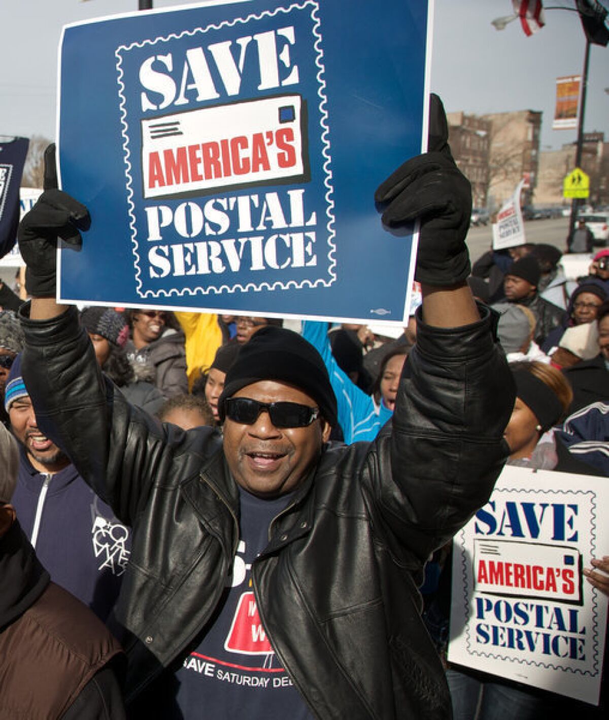 Postal workers in Chicago rally in support of keeping Saturday mail delivery, which the U.S. Postal Service plans to discontinue as a cost-cutting move.