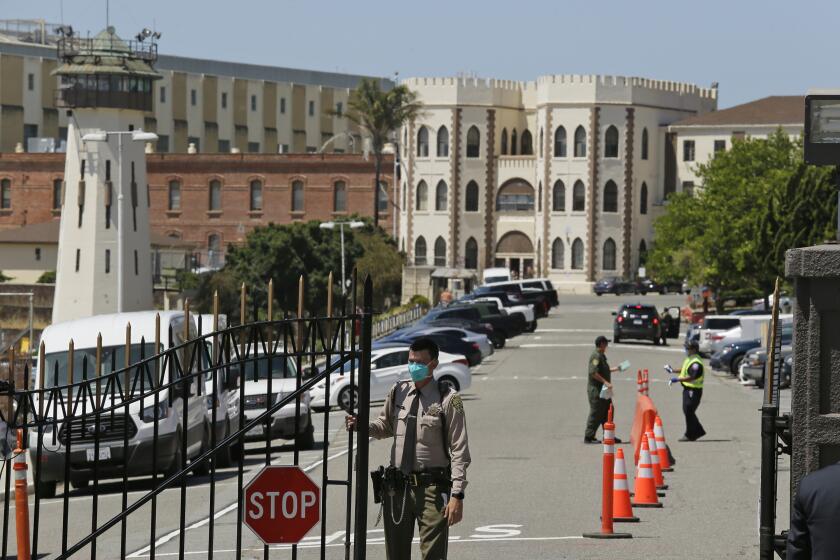 FILE - In this July 9, 2020, file photo, a correctional officer closes the main gate at San Quentin State Prison in San Quentin, Calif. California's corrections secretary is retiring after two years in a job that Gov. Gavin Newsom on Friday, Aug. 28, said involved "unparalleled challenges" _ most recently coronavirus outbreaks that swept state prisons and increasing social pressure to ease mass incarceration. Ralph Diaz will retire Oct. 1 after 30 years with the California Department of Corrections and Rehabilitation. (AP Photo/Eric Risberg, File)