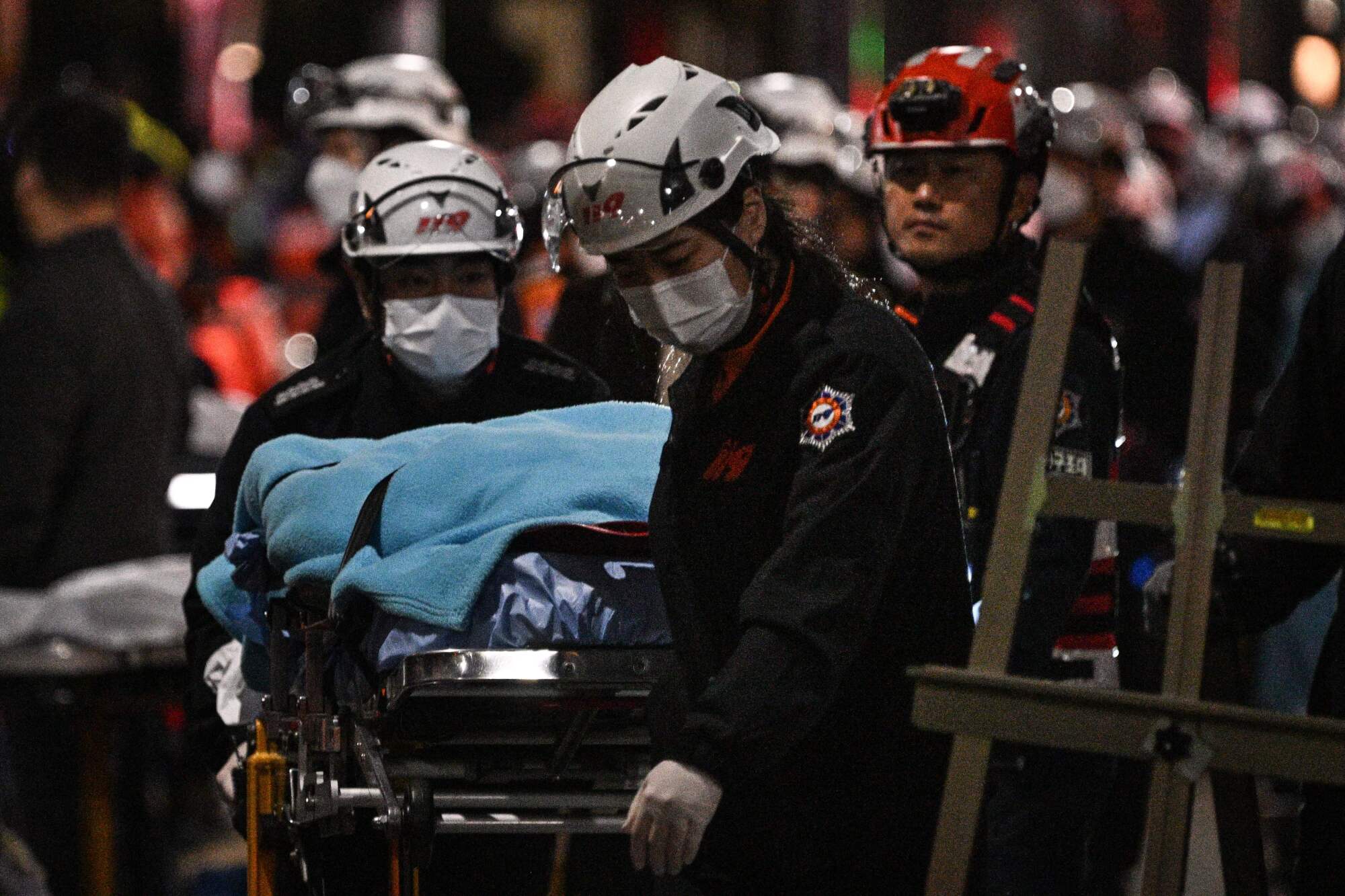 Emergency workers transport a victim on a gurney 