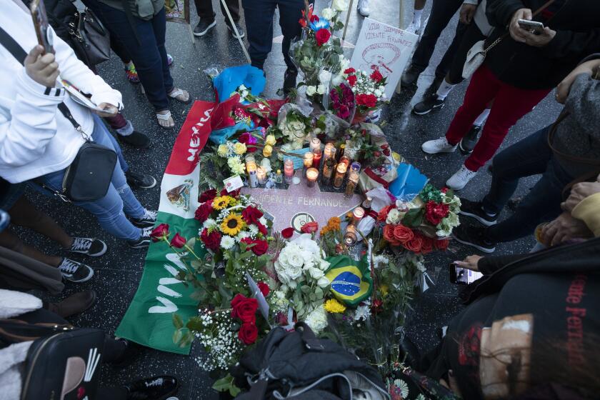HOLLYWOOD, CA - DECEMBER 12: Vicente Fernandez's star on Hollywood Boulevard is decorated by fans during a makeshift memorial on Sunday, Dec. 12, 2021. (Myung J. Chun / Los Angeles Times)