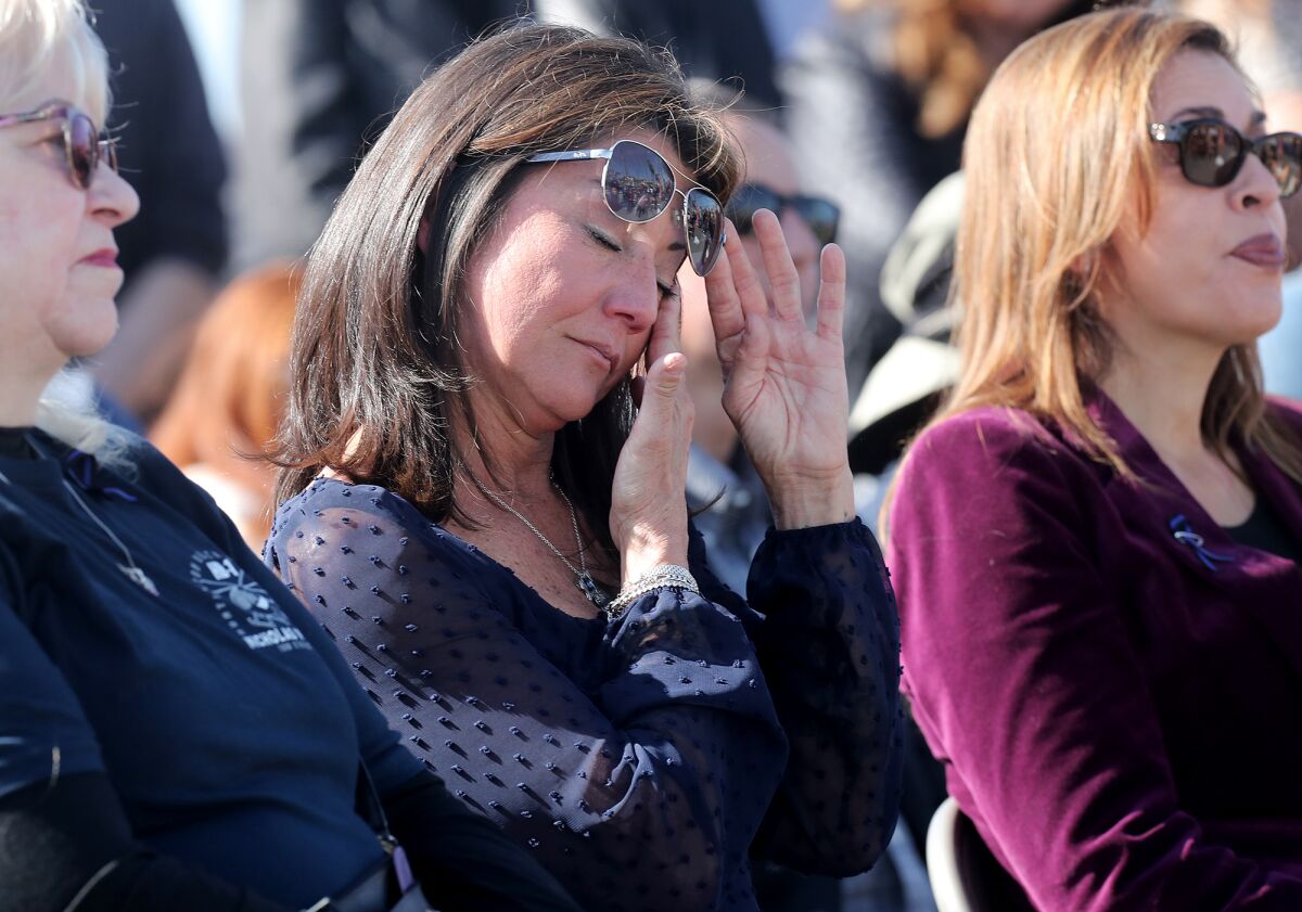 Kristi Vella, Officer Nicholas Vella's wife, wipes away tears during Saturday's ceremony.