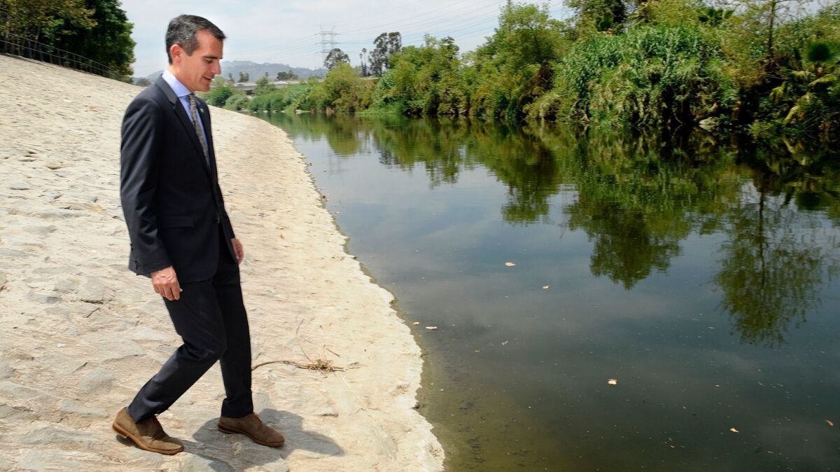 L.A. Mayor Eric Garcetti walks down to the L.A. River after a press conference.
