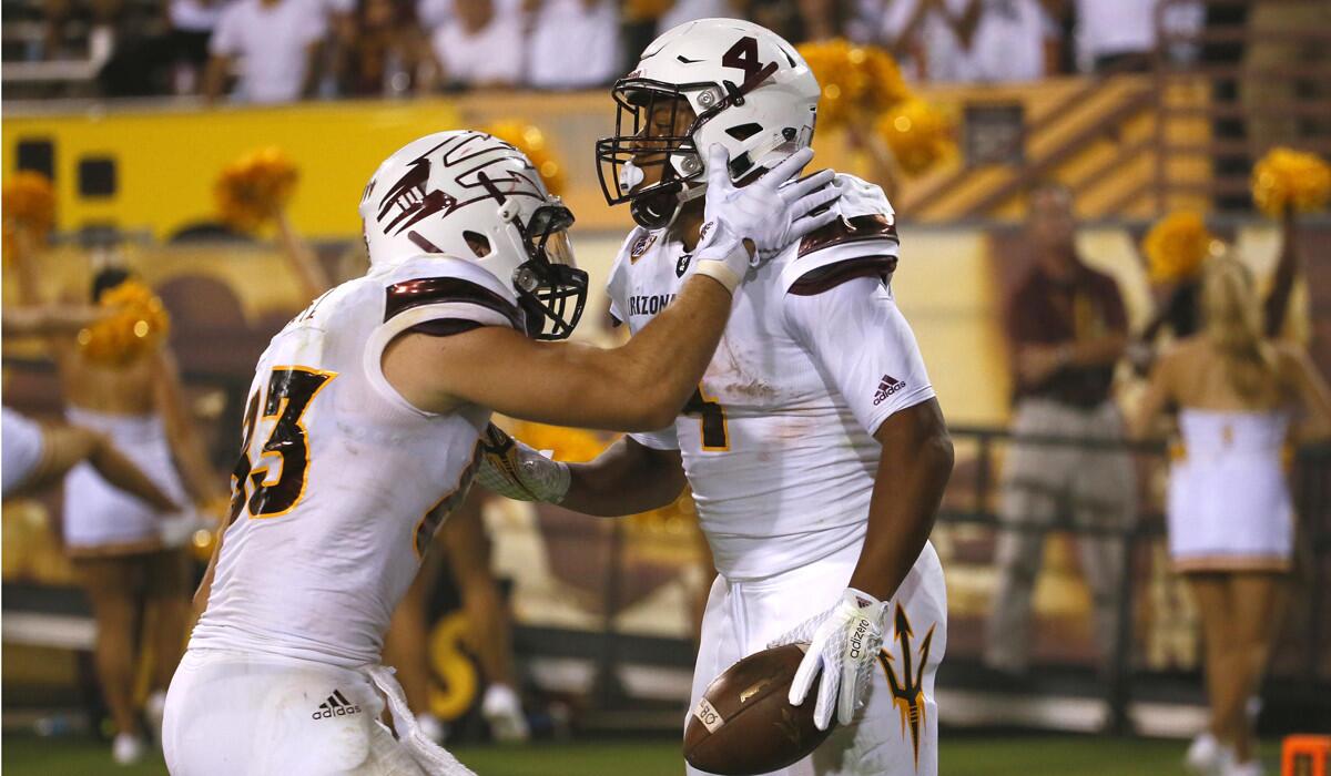 Arizona State running back Demario Richard, right, celebrates his 93-yard touchdown run with tight end Kody Kohl during the second half against New Mexico on Sept. 18.