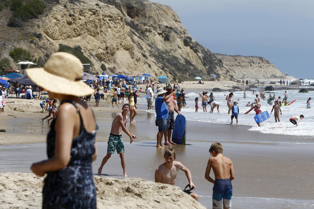 Beachgoers enjoy Crystal Cove State Beach in Newport Beach Thursday.