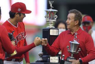 Shohei Ohtani bumps fists with Angels owner Arte Moreno