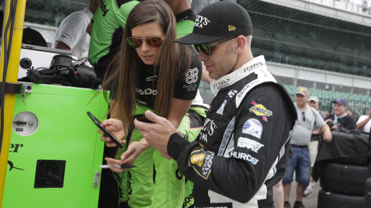 Danica Patrick talks with Ed Carpenter during a practice session for the Indianapolis 500 on May 21.