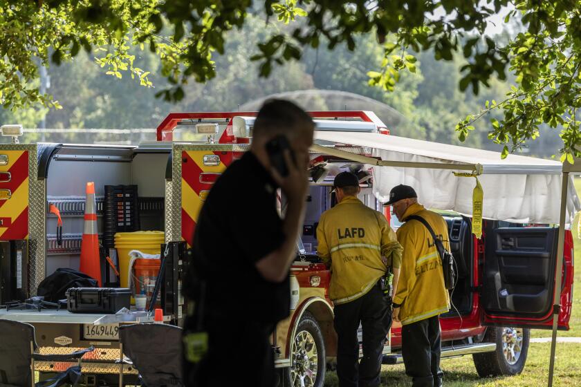 ENCINO, CA - JUNE 25: Ten Los Angeles Fire Department firefighters were injured Monday afternoon battling a fire at a homeless encampment near the Hjelte Sports Center in Encino, CA. Investigators were still at the scene Tuesday morning Tuesday, June 25, 2024. (Myung J. Chun / Los Angeles Times)