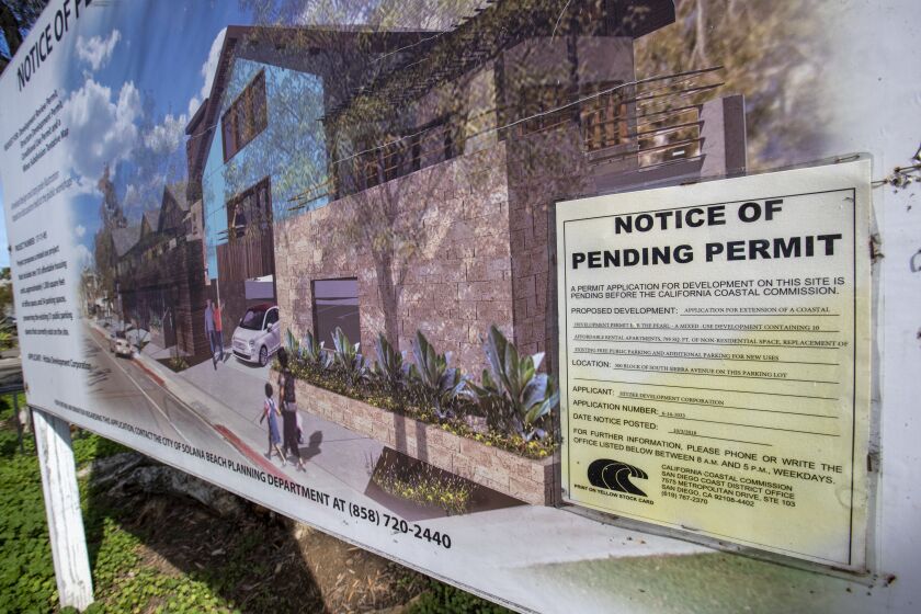 SOLANA BEACH, CALIF. -- TUESDAY, JANUARY 14, 2020: A notice of permit application sign is posted the site of a proposed affordable housing project near million-dollar condos on S. Sierra Ave, Solana Beach, a parking lot behind Sand Pebbles Resort in Solana Beach. It's a 10-unit project that has been in the works for the last 10 years and has yet to break ground in Solana Beach, Calif., on Jan. 14, 2020. (Allen J. Schaben / Los Angeles Times)