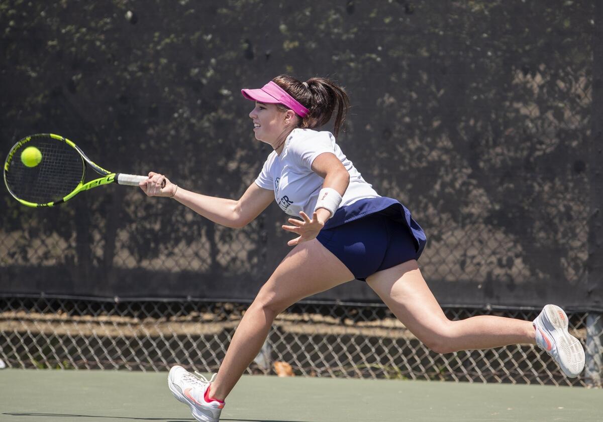 Newport Coast's Roxy MacKenzie returns a shot to Santa Monica's Erica Ekstrand in the girls' 18-and-under round of 64 singles match at the 117th USTA Southern California Junior Sectional Championships on Wednesday in Fountain Valley.
