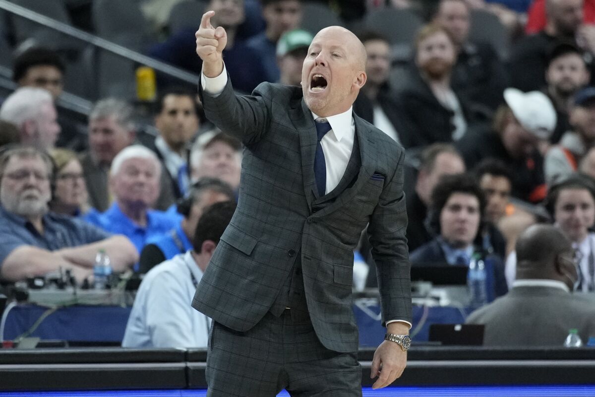 UCLA head coach Mick Cronin motions towards the court.