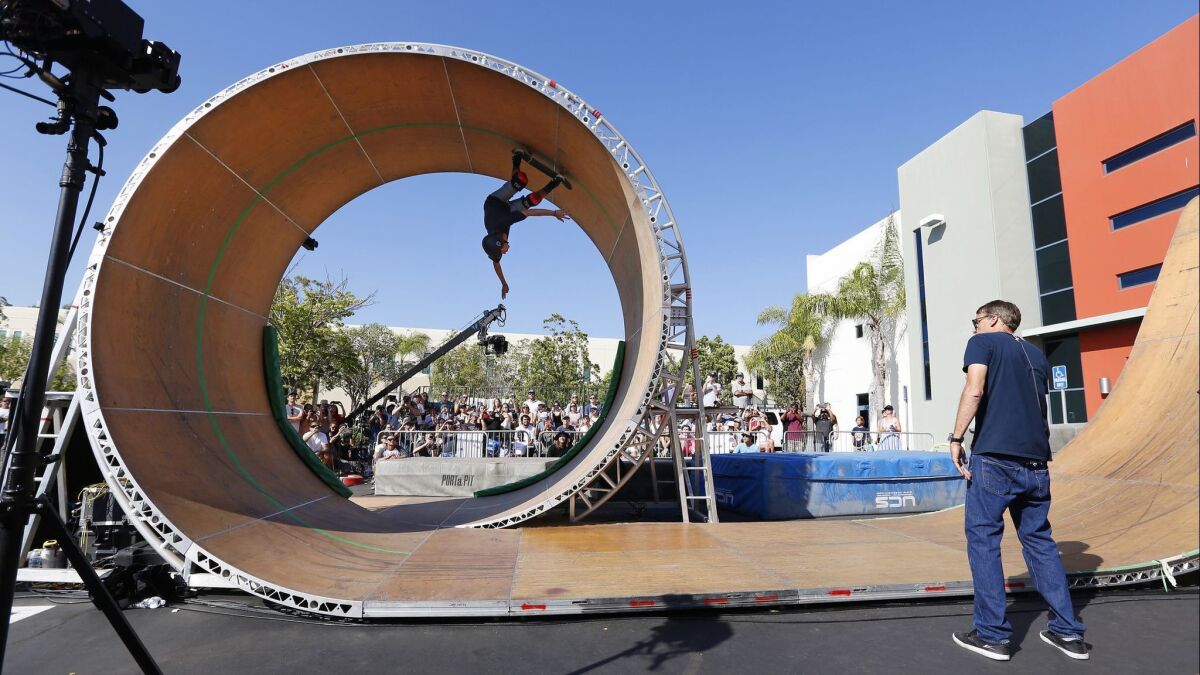 Tony Hawk, right, watches skater Jeromy Green complete the Loop Challenge Live in Vista on Sunday.