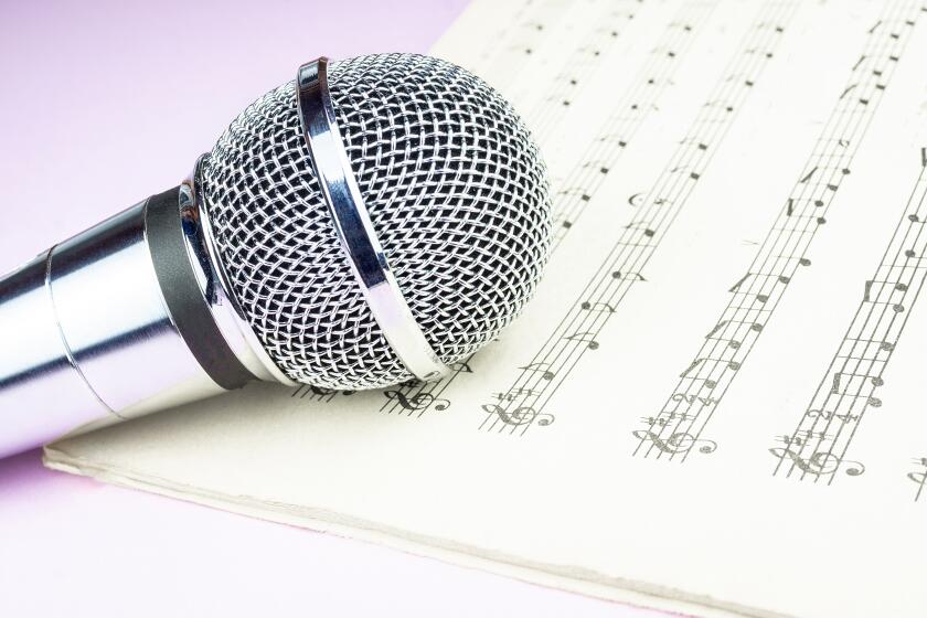 The musical microphone lies on a clean sheet music.