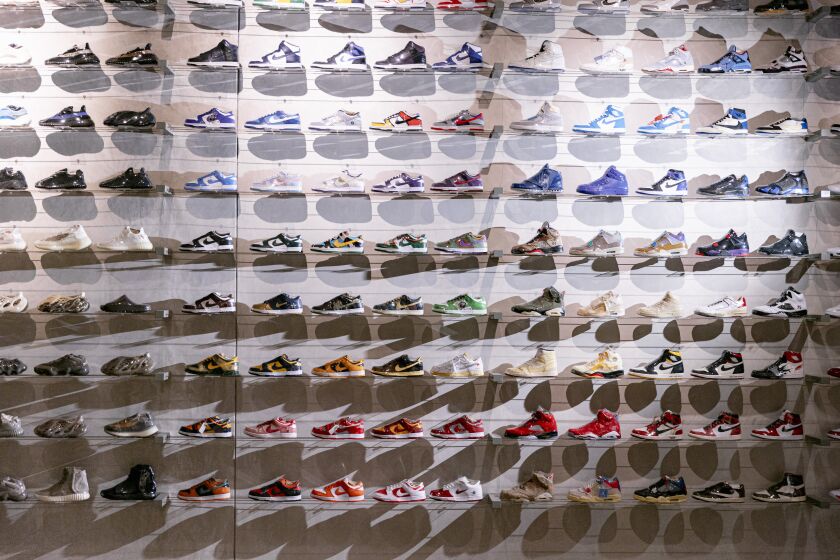 Los Angeles, CA - July 07: Flight Club's floor-to-ceiling wall of consignment sneakers is seen inside the store on Thursday, July 7, 2022 in Los Angeles, CA. A scissor lift is a fixture in the store, for when customers want to purchase sneakers from high on the wall. (Wesley Lapointe / Los Angeles Times)