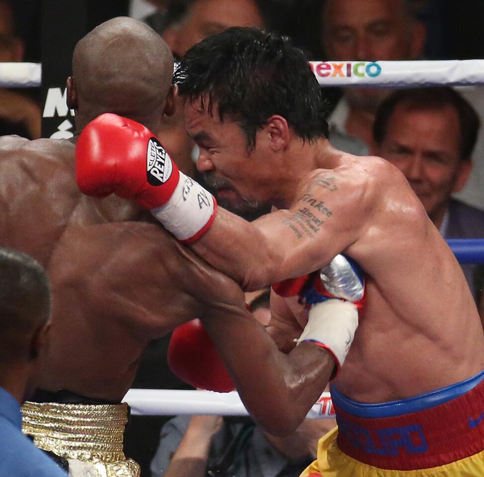 Floyd Mayweather Jr. connects with a body shot to the ribs of Manny Pacquiao in the 11th round.