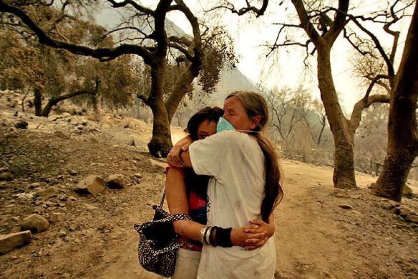 Julie Garcia, 59, and her daughter Jessi Garcia, 19, hug each other Tuesday after seeing their home gutted by the Station fire that swept through their neighborhood on La Paloma Canyon Road at Vogel Flat in Tujunga.