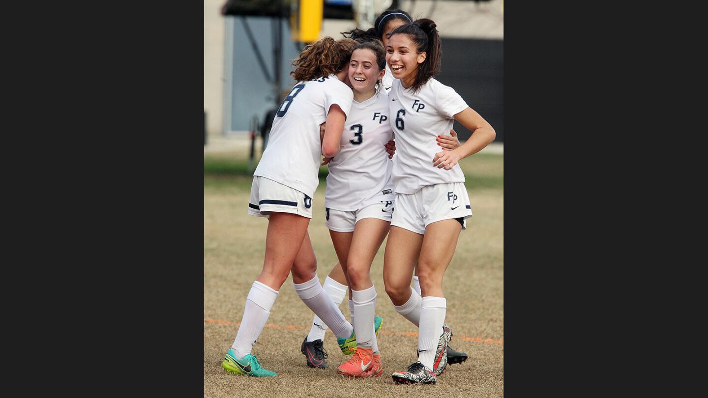 Flintridge Prep's Mona Cesario, center, is congratulated by teammates Helen Schaefer and Julia Gonzalez after kicking a goal against Paramount in a CIF Southern Section Division III first-round girls' soccer match at Flintridge Preparatory School on Thursday, February 16, 2017.